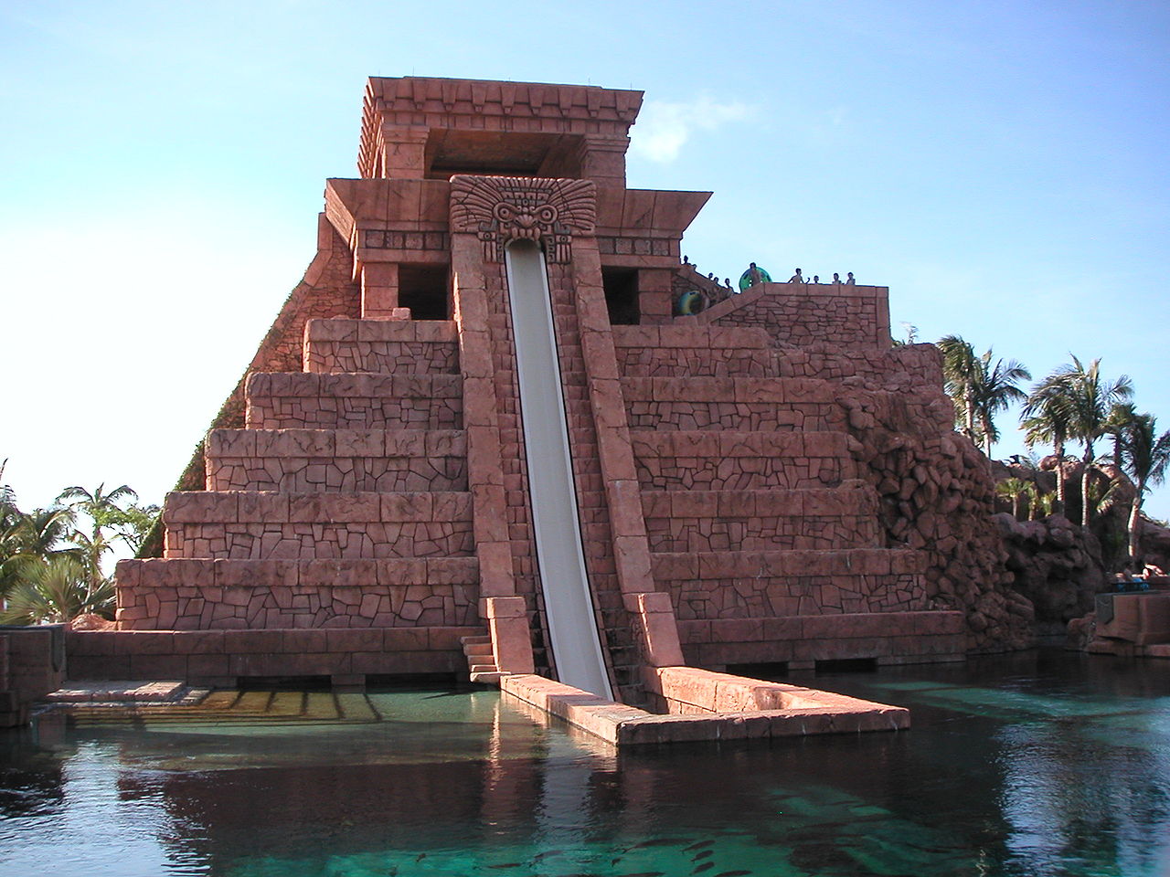 Sharks await at the bottom of Mayan Temple Water Slides at Atlantis, Paradise Island, Nassau, Bahamas. Visitors on tubes slide past these sharks inside rectangular acrylic tunnels.