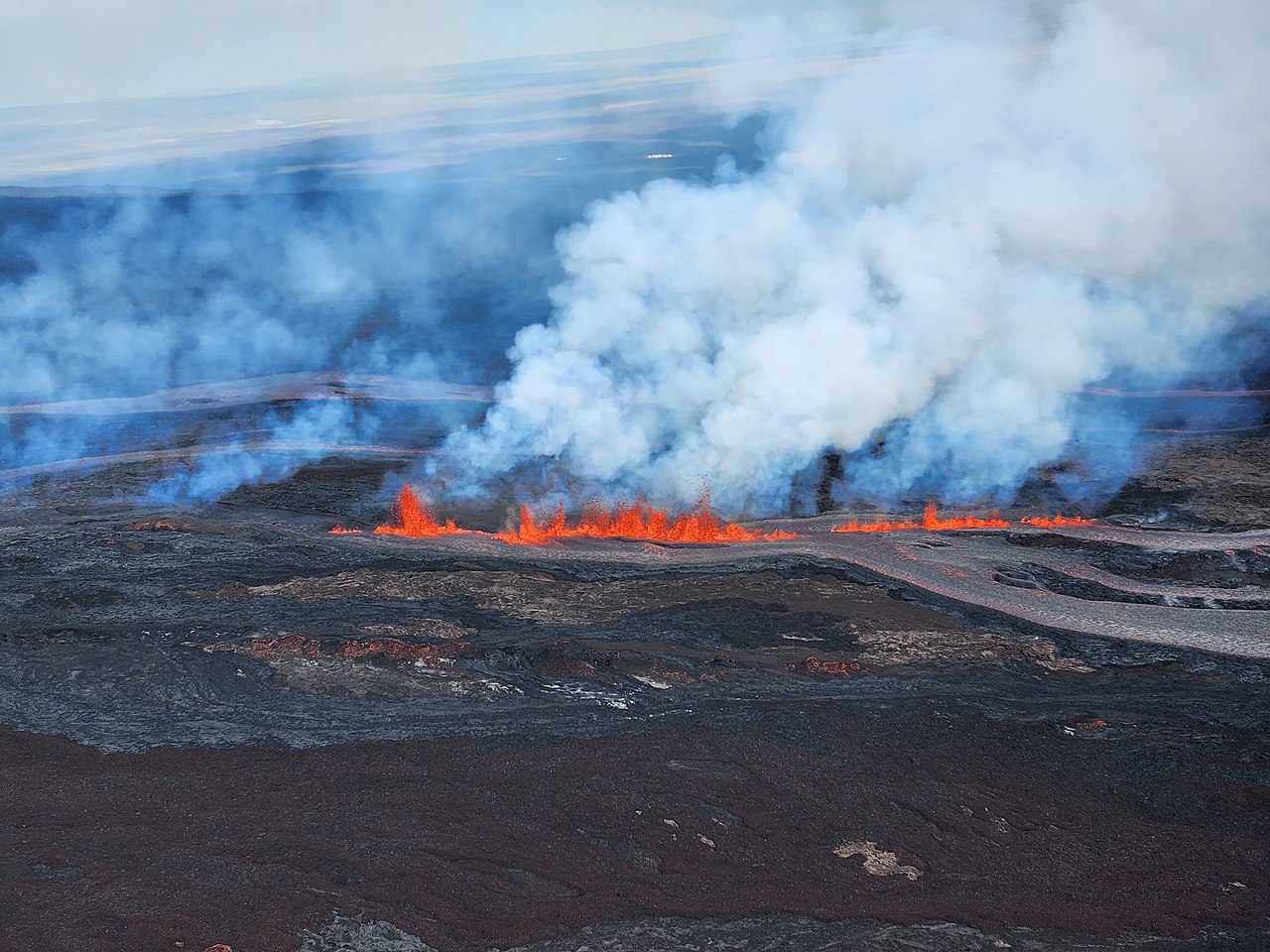 Lava fountains along a fissure on Mauna Loa's Northeast Rift Zone at approximately 9:30 a.m. HST on November 28, 2022. The photo was taken looking toward the north. USGS photo by K. Lynn.