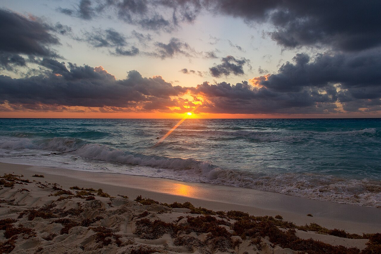 500px provided description: Sunrise over the sea from the beach in Canc?n, Mexico. A line of buoys and floats to the left. [#sky ,#sunrise ,#sea ,#water ,#mexico ,#beach ,#cancun ,#travel ,#blue ,#sun