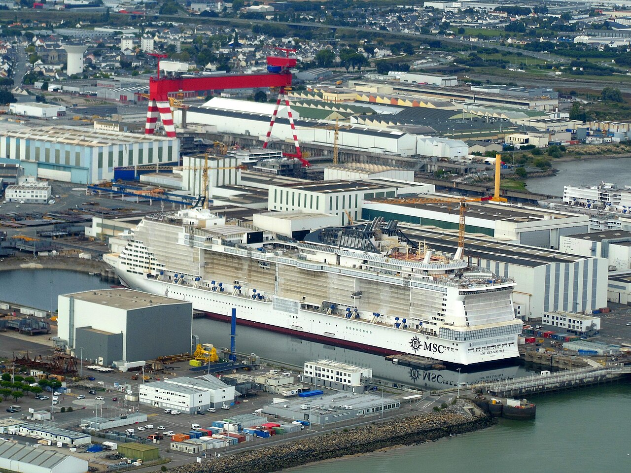 Aerial view of the Chantiers de l'Atlantique complex in Saint-Nazaire, Loire-Atlantique, France. MSC Bellissima is under construction.