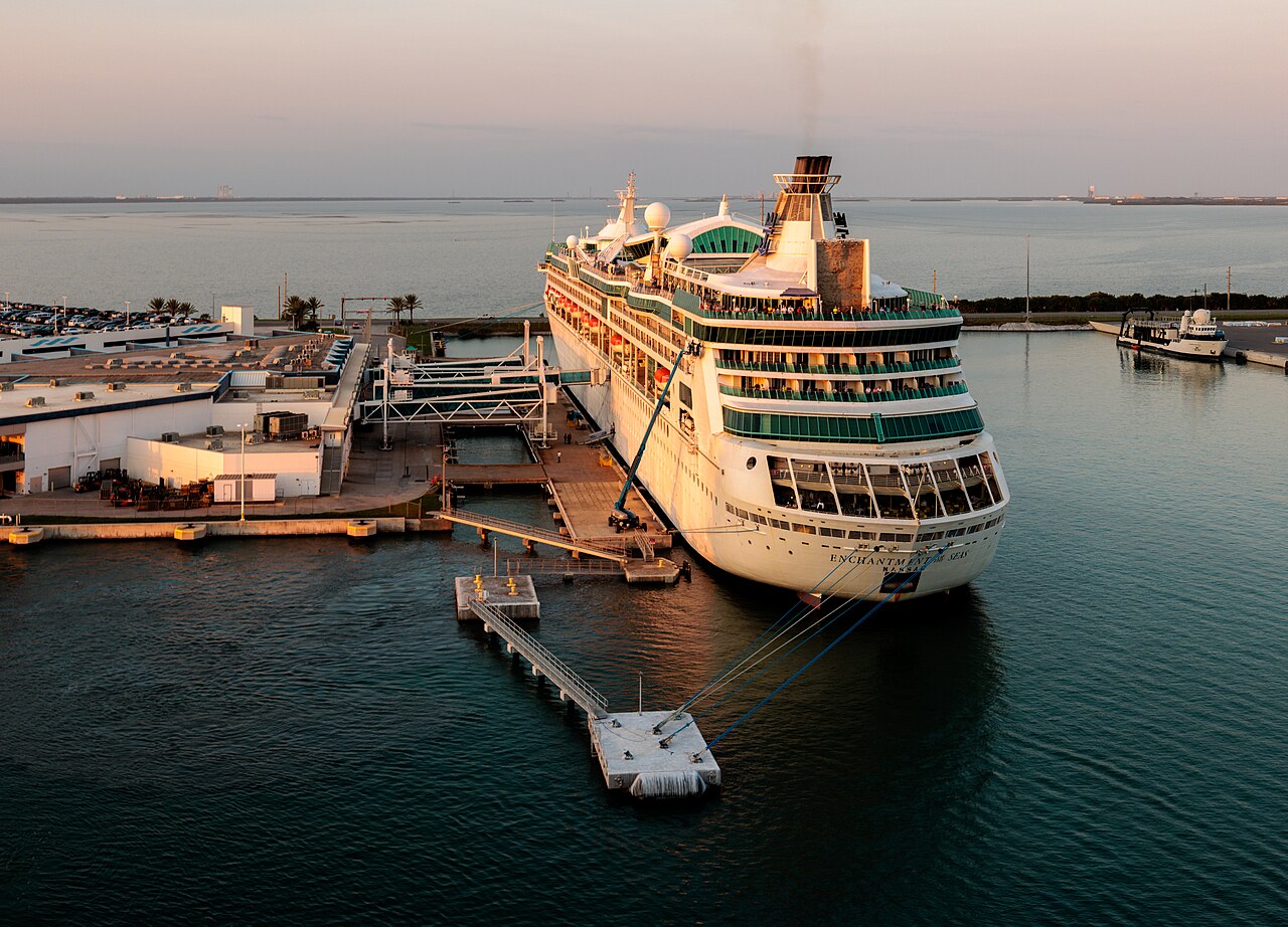 Royal Caribbean's Enchantment Of The Seas, with Kennedy Space Center on the horizon, including space launch facilities for both NASA and SpaceX.