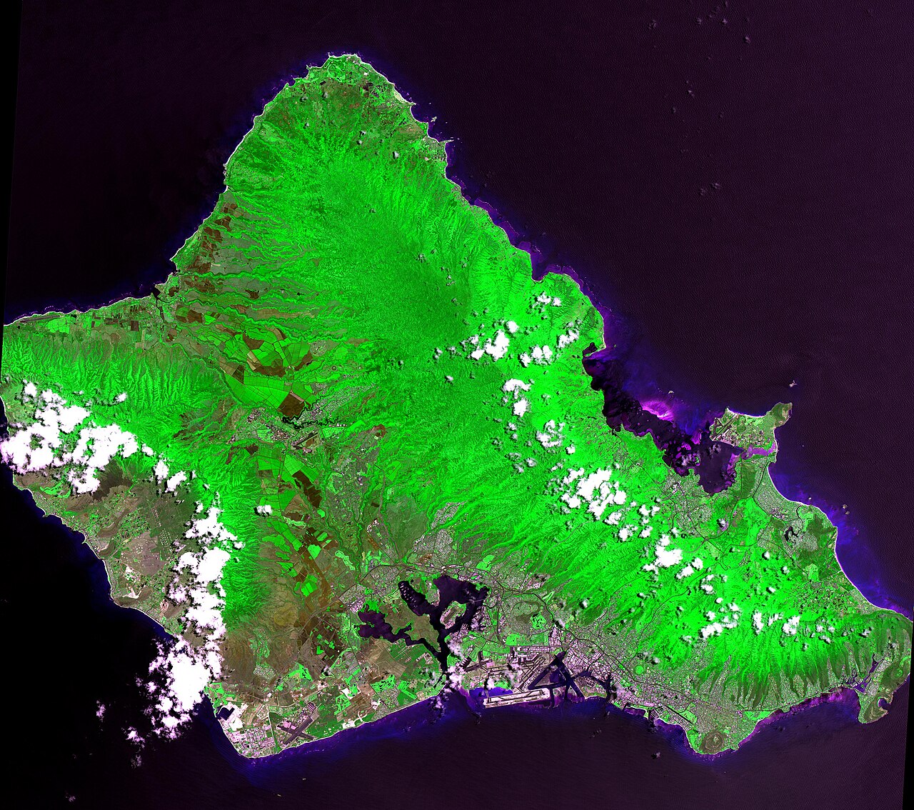 This 60 by 55 km ASTER scene shows almost the entire island of Oahu, Hawaii on June 3, 2000. Bands 2, 3, and 1 are displayed in red, green and blue, making the vegetation appear green. Oahu is the com