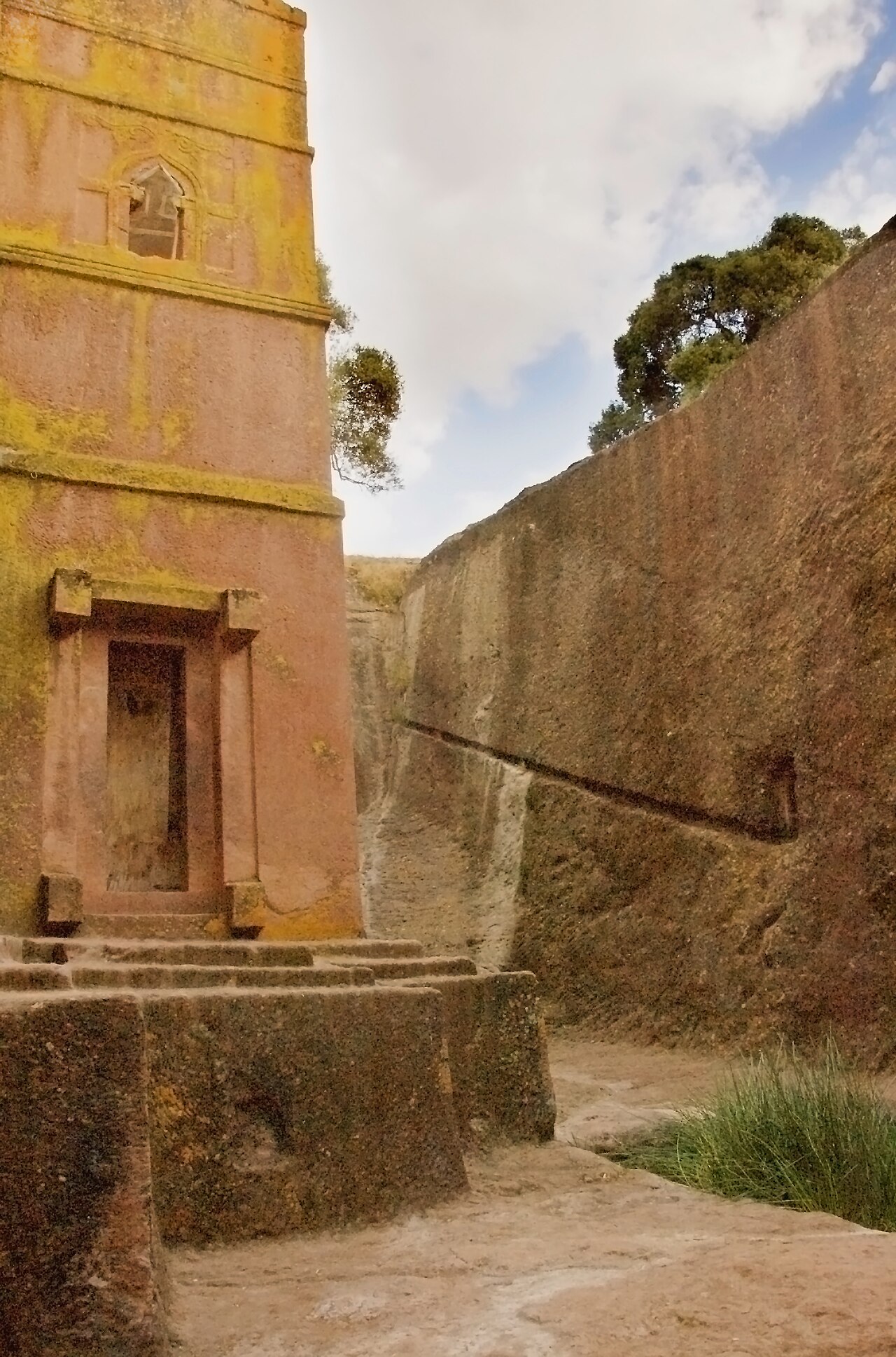 This view of the 13th century rock-hewn church of Bet Giorgis shows the southwest corner of the structure and the south wall of the vast rectangular pit created when the church was carved out of livin