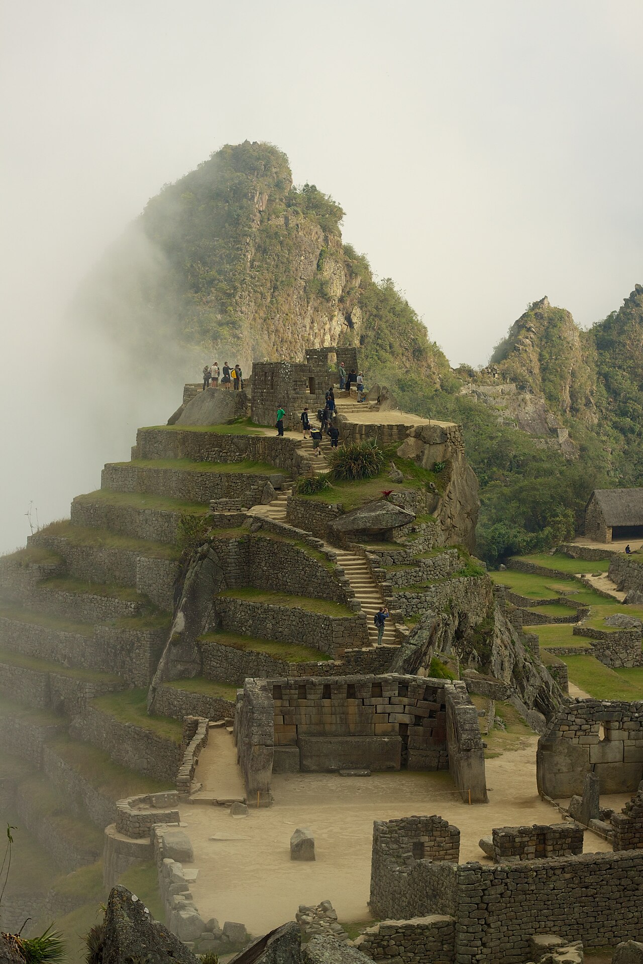 The Sacred Plaza and Principle Temple with the pyramidal hill of the Intihuatana, still partly shrouded in mist, rising behind.