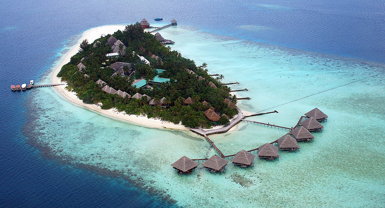Aerial shot of a small island on a coral reef in the Maldives