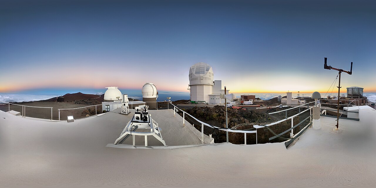 This panorama shows a group of observatories at the summit of Haleakalā on the Hawaiian Island of Maui. The largest telescope at the center is the Daniel K. Inouye Solar Telescope.