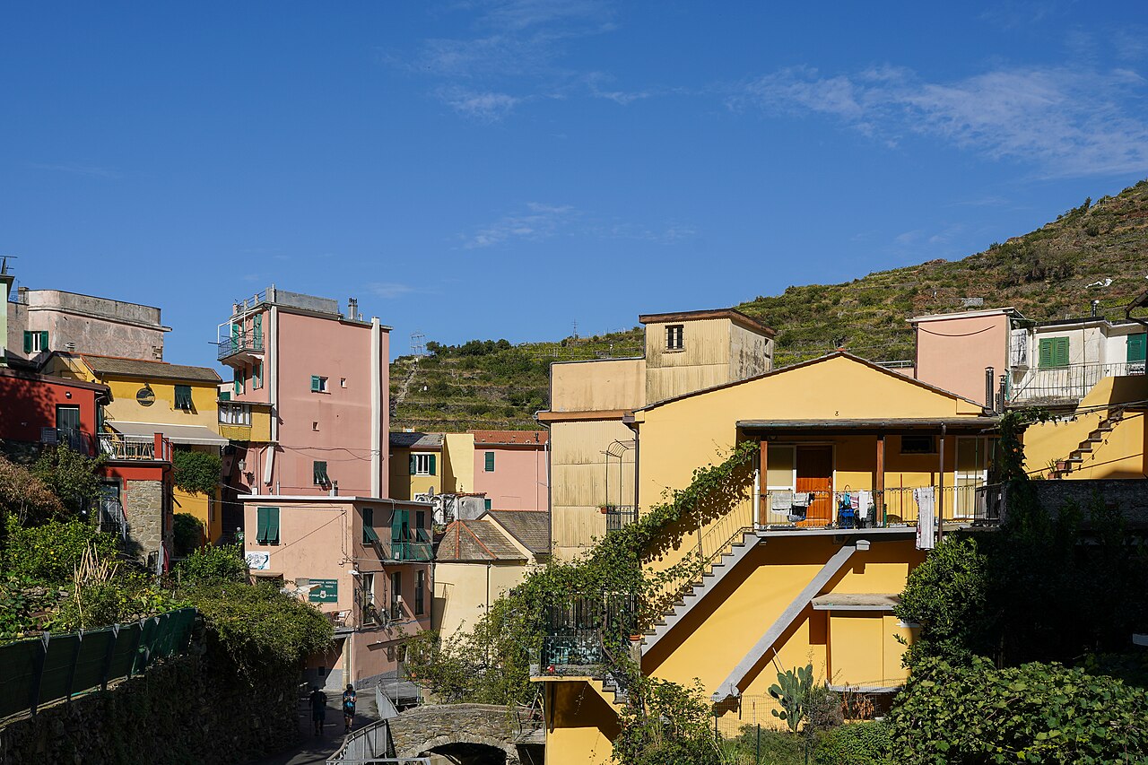 Brightly coloured buildings in Manarola, view west from the road up towards Volastra, Cinque Terre, Liguria, Italy