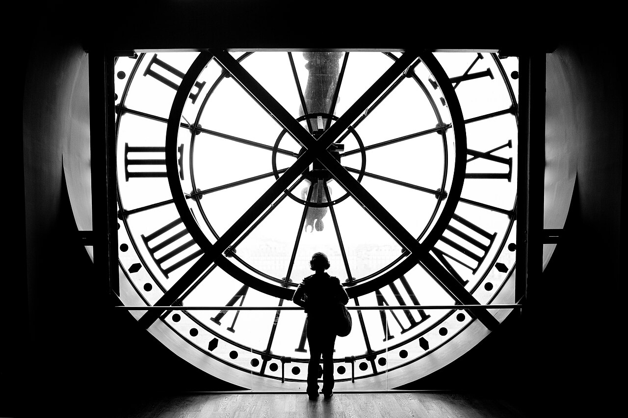 Looking at Paris and the Seine River through windows from the top floor of the Musée d'Orsay.