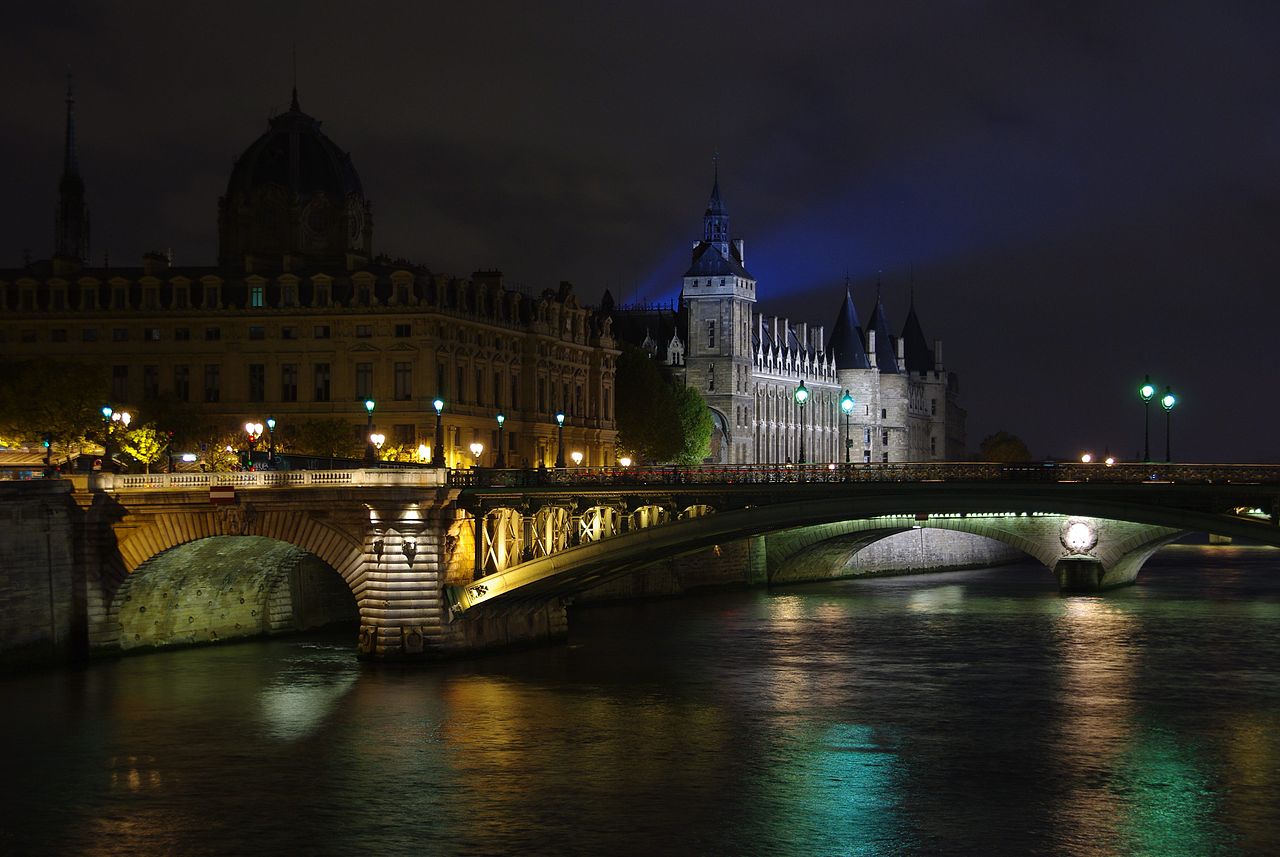 The Notre Dame Bridge, the Seine River, the Conciergerie and the light from the Eiffel Tower.