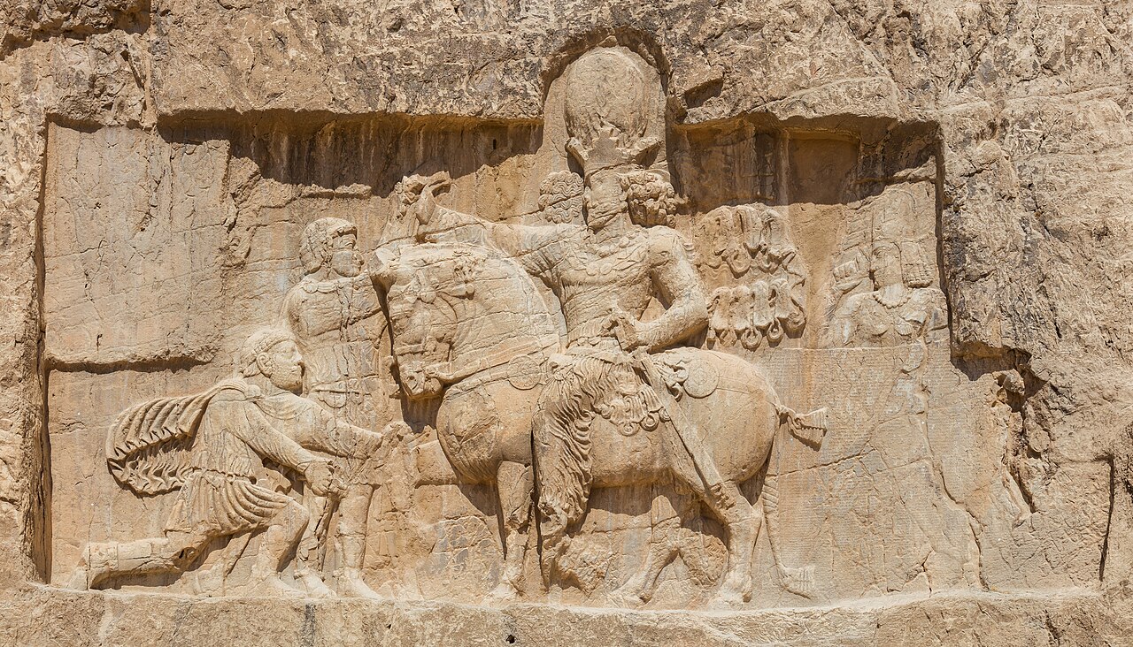 Relief of triumph of Shapur I over Valerian at Naqsh-e Rostam (ca. 241–272 AD), located 3 km north of Persepolis. It is the most impressive of eight Sasanian rock carvings cut into the cliff beneath t
