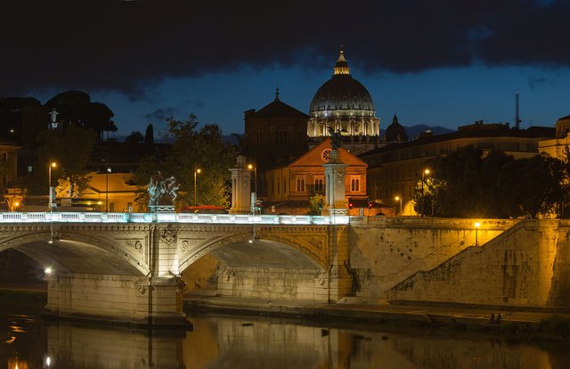 Dusk at Saint-Peter Basilica, Vittorio-Emmanuele II bridge, and Tiber river. Rome, Italy.
