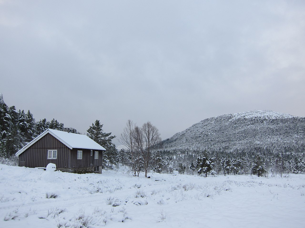 Cabin in Rekdalsetra covered in snow in a winter panorama. This area is located in the mountains behind the village Rekdal in the municipality of Vestnes on the west coast of Norway in the region Roms