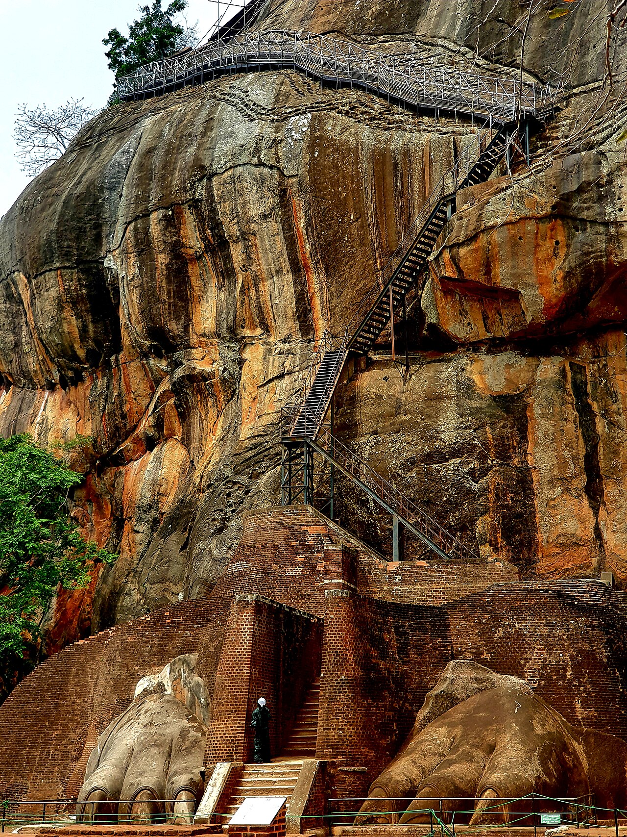 The Lion Gate entrance to Sigiriya rock fortress, with massive carved lion paws flanking the staircase on either side.