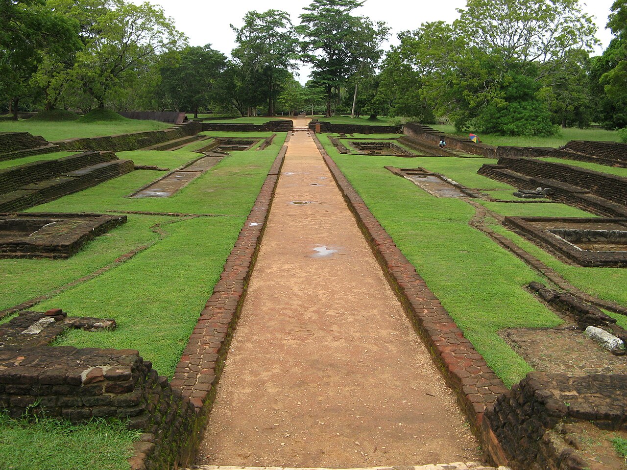 Symmetrical water gardens at the base of Sigiriya fortress, with rectangular pools and fountains along the western approach.