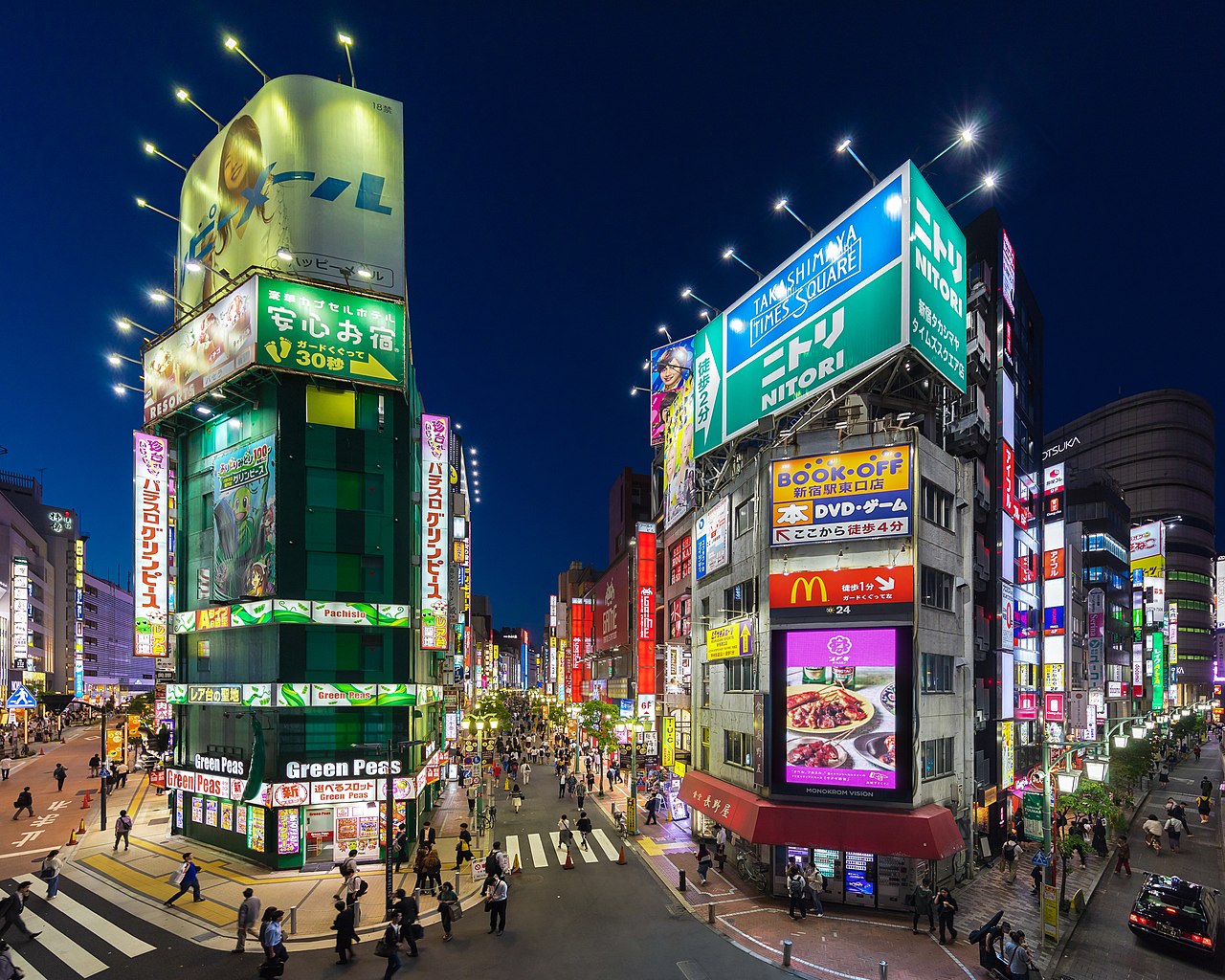 Facades of Green Peas pachisuro parlor and Naganoya restaurant, colorful neon street signs at blue hour, view from Koshu-kaido Avenue, Shinjuku station JR East. Entertainment district in Shinjuku, Tok