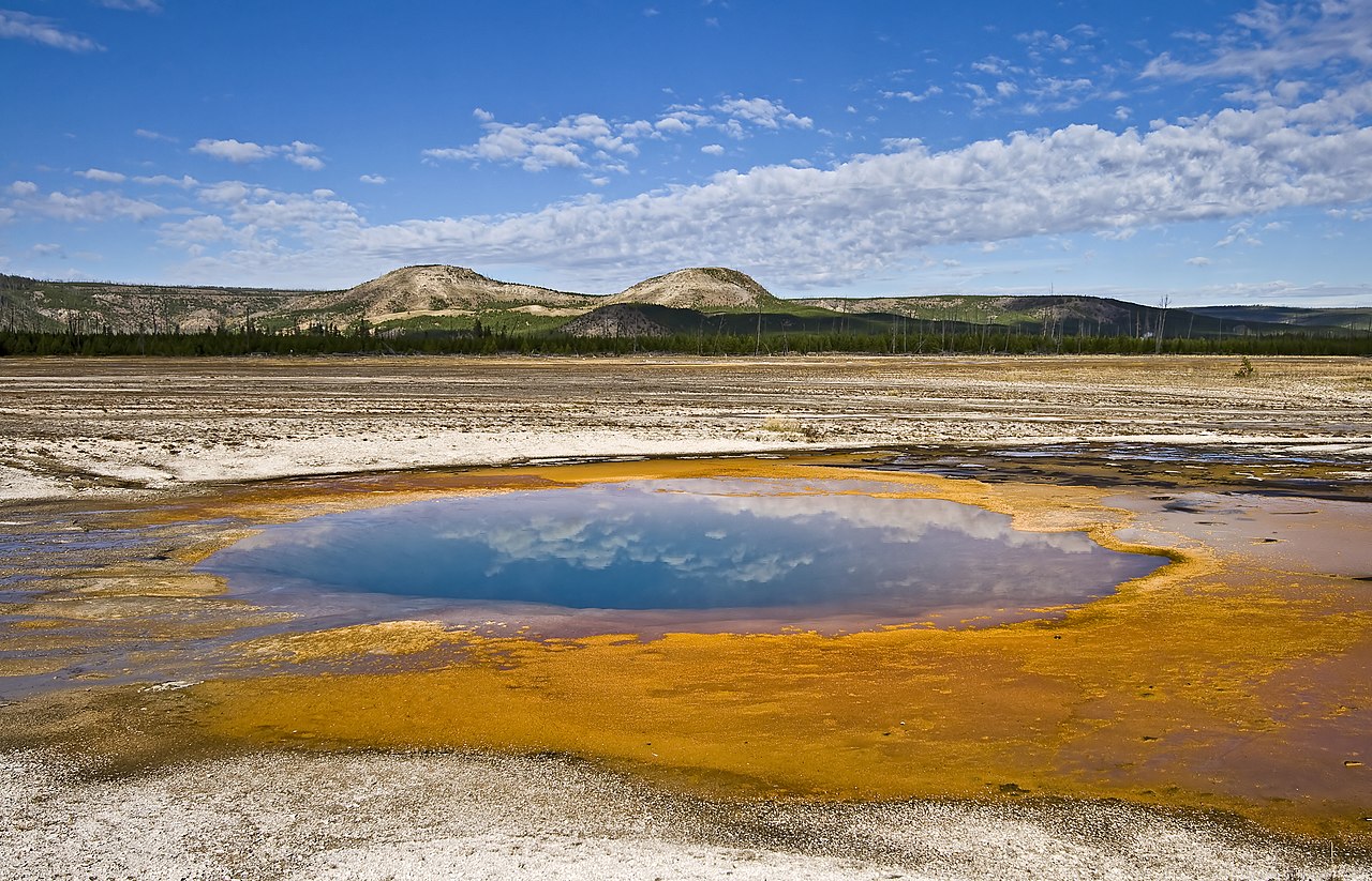 Opal Pool, with Twin Buttes beyond, in the Midway Geyser Basin, Yellowstone National Park, Wyoming, USA